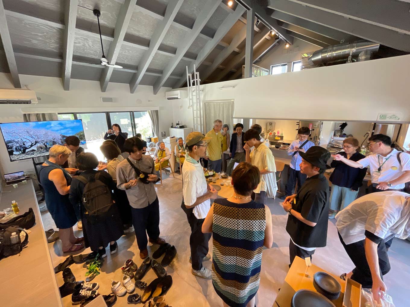 Photo of people mingling while eating and drinking