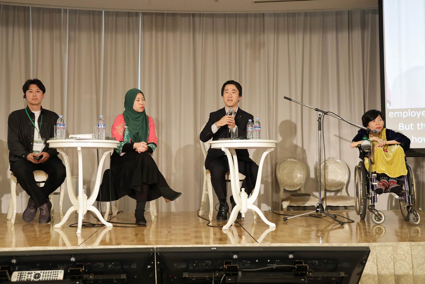Photo of Masahiro Sasayama, Dissa Syakina Ahdanisa, Junto Ohki, Nguyen Van (in wheelchair)