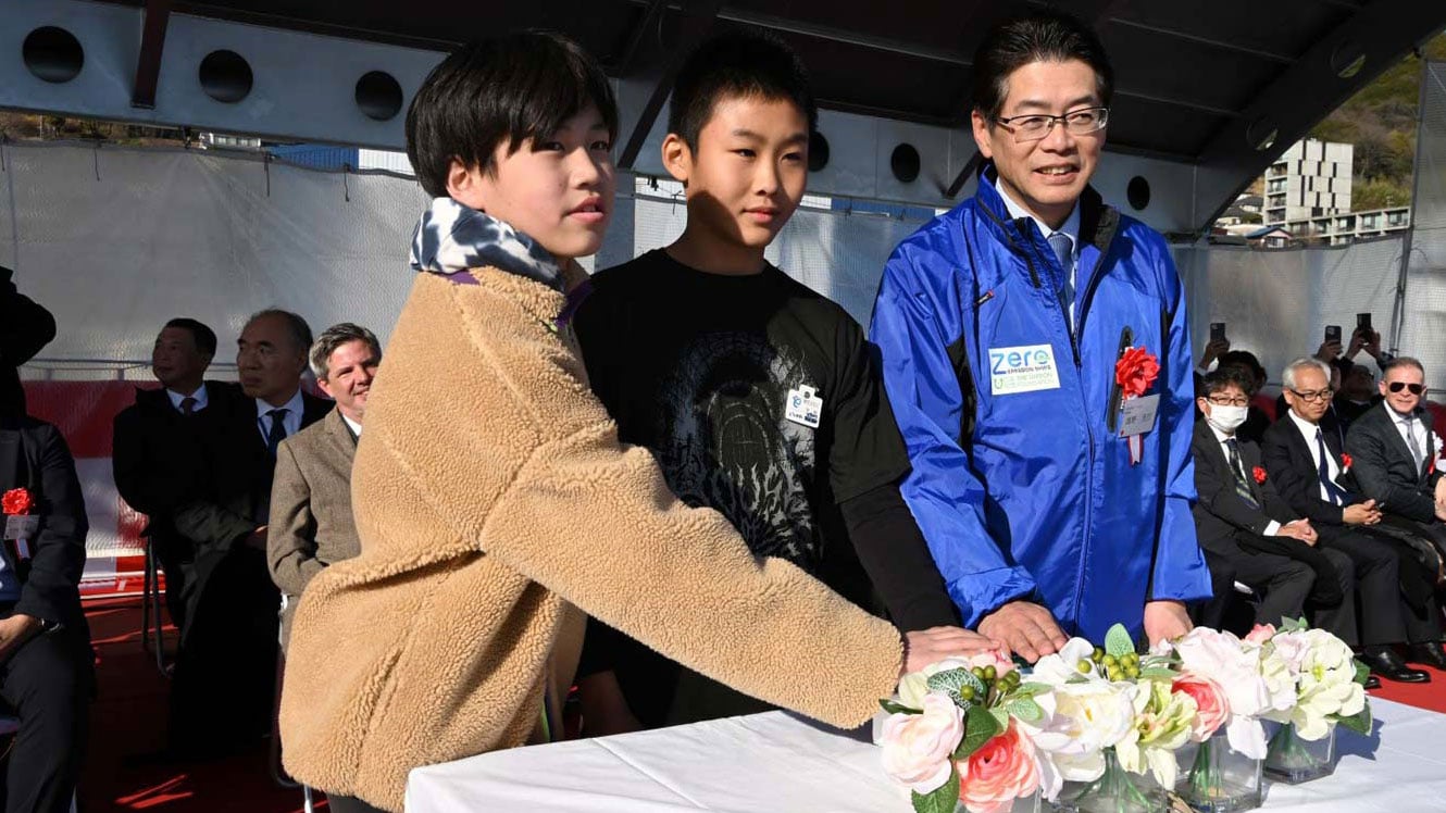 Photo of two elementary school children with hands on a switch