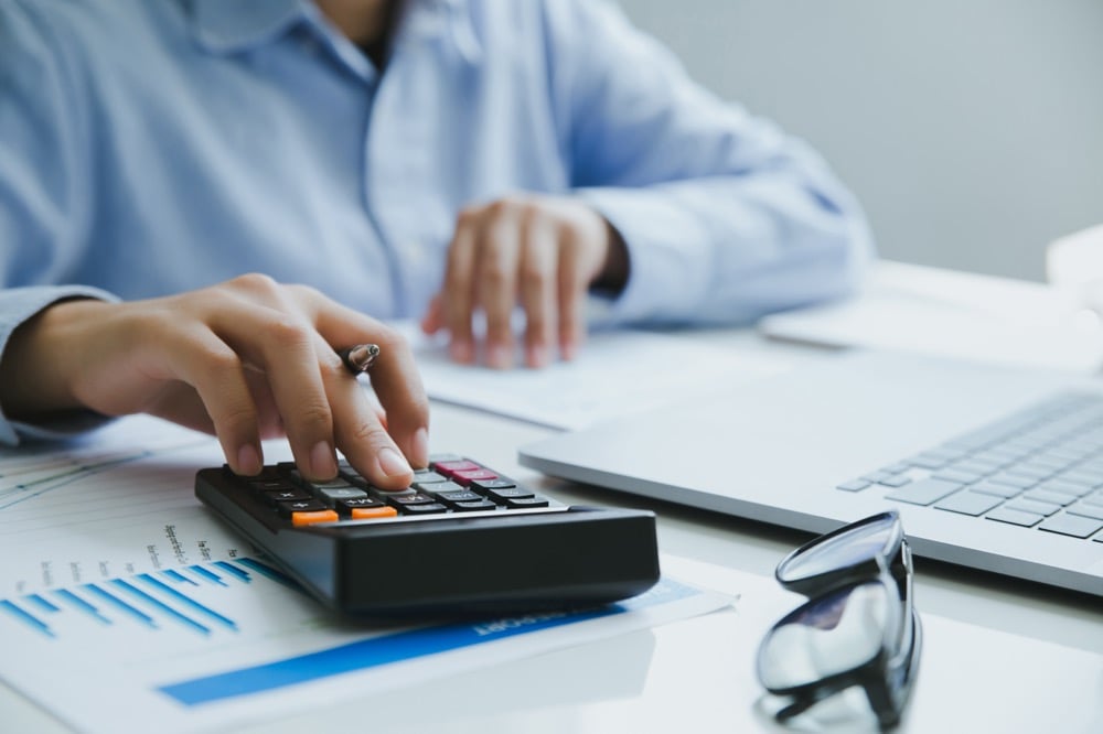 Man using a calculator