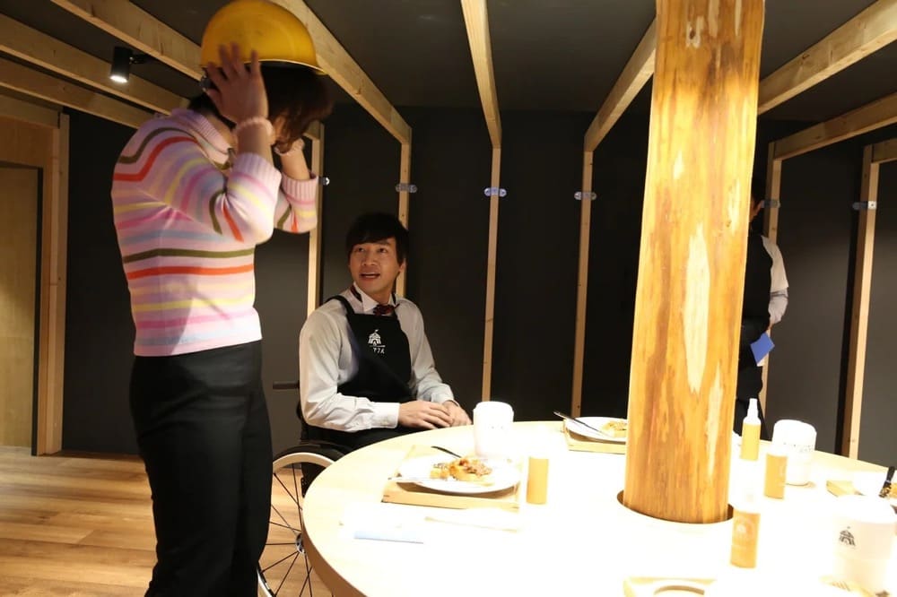 A person with a bipedal walking impairment puts on a helmet