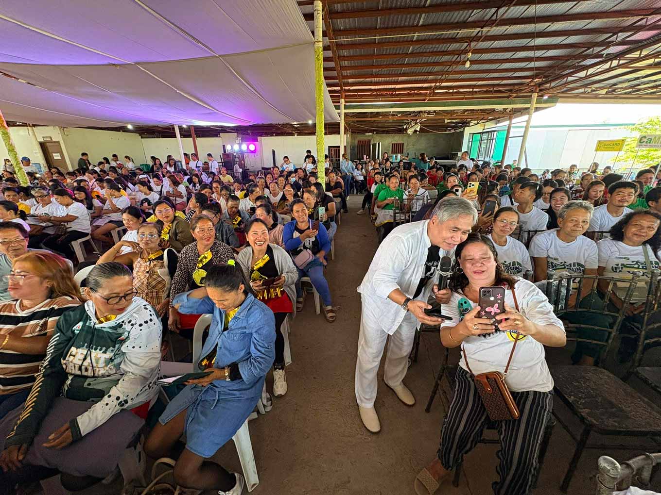 Photos: Jaime Aristotle Alip stands with CARD members in Masbate, a province where CARD MRI’s long-term presence has supported families in building more stable livelihoods.