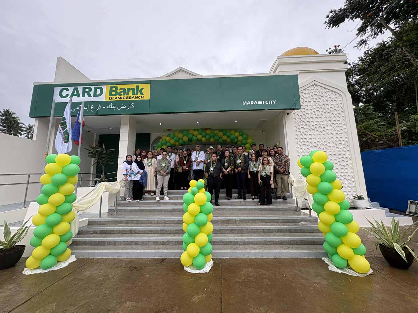 Photo: Community members and CARD representatives gather in front of a CARD Bank Islamic Bank Branch in Marawi during its opening ceremony, highlighting access to Sharia-compliant financial services for Muslim communities.