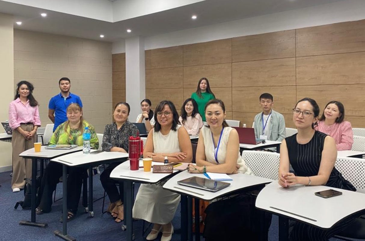 Photo of women sitting at desks in a classroom