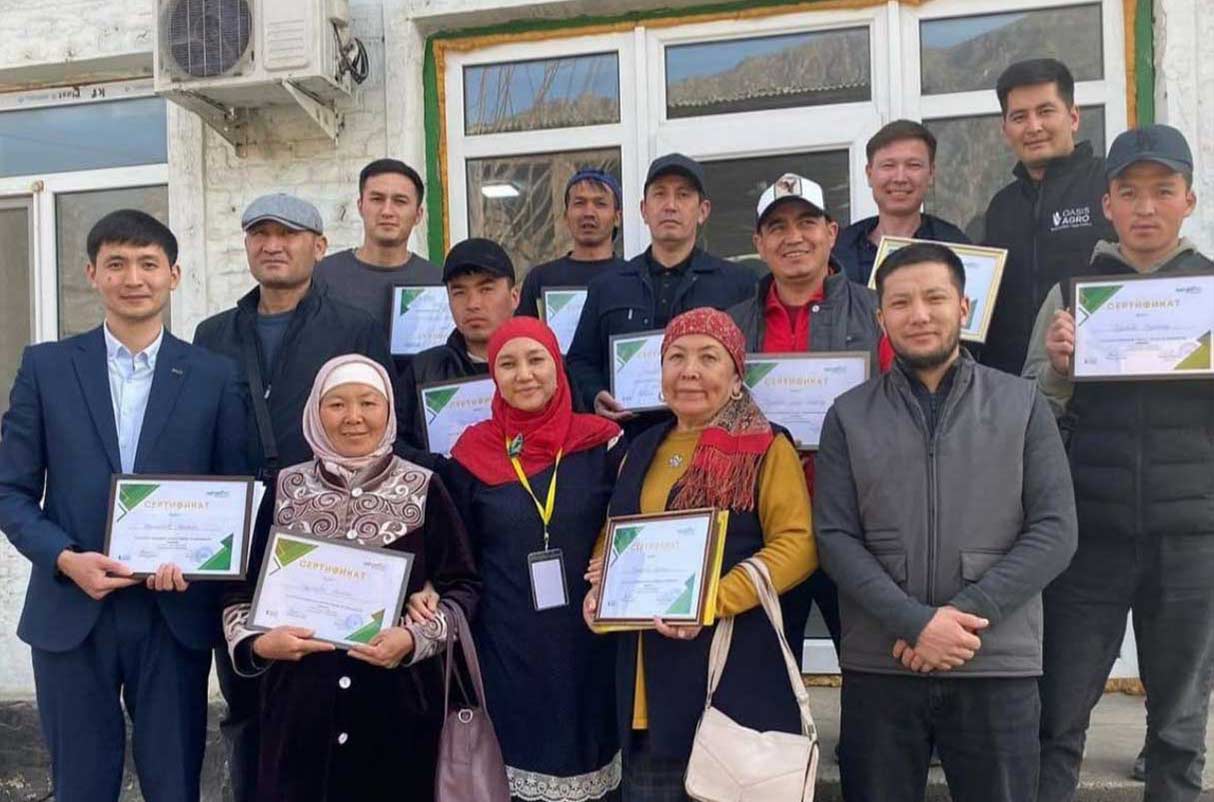 Group photo of poultry farmers holding diplomas