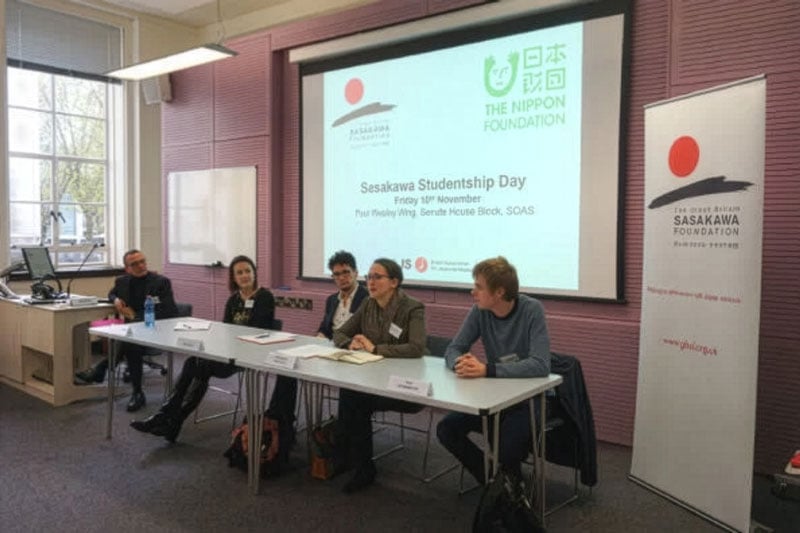 Photo of speakers seated at a table