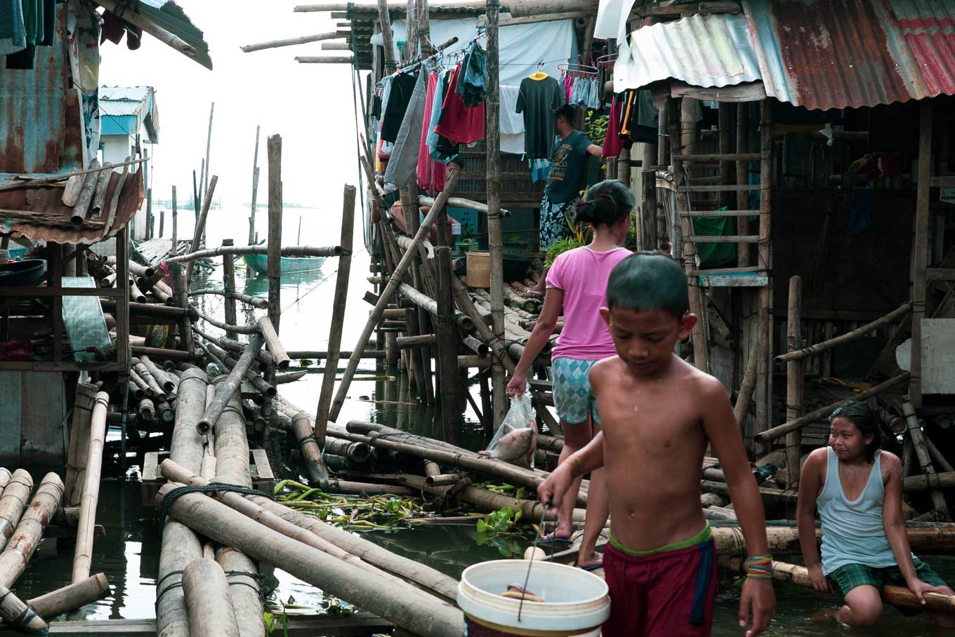 Photo of children in a waterfront shanty