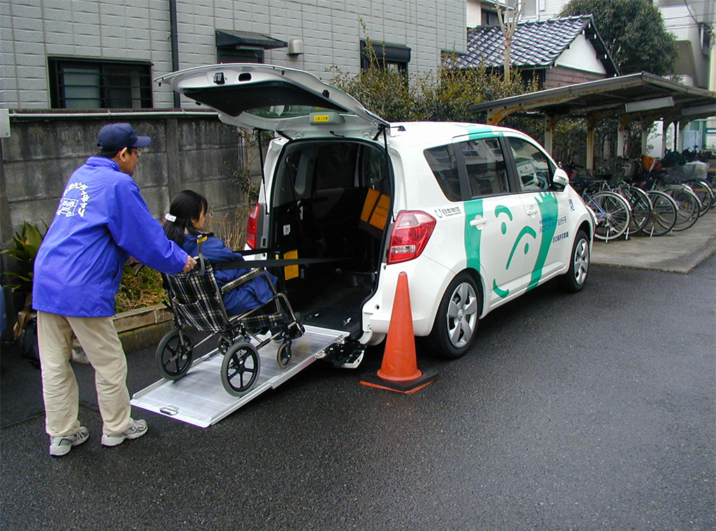 Photo of a wheelchair user boarding a wheelchair-accessible vehicle